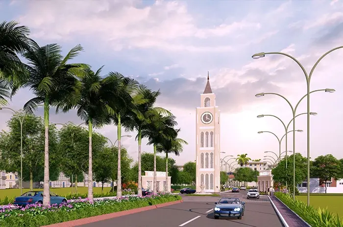 Wide boulevard lined with palm trees and a clock tower in Mansha Heritage